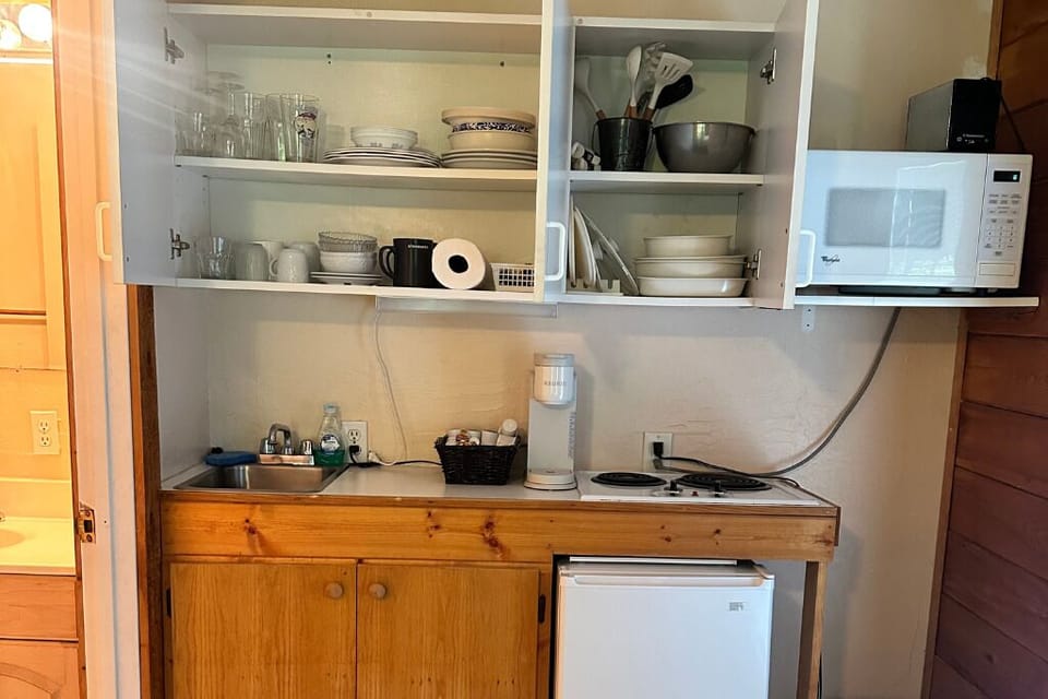 Inside the cabinets, we have glassware, dinnerware, and cookware. 