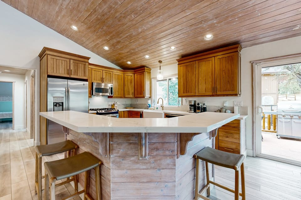 Fully equipped cabin kitchen with ample cabinetry, stove, fridge, and coffee maker—perfect for cooking meals, morning coffee, and feeling right at home on your stay.