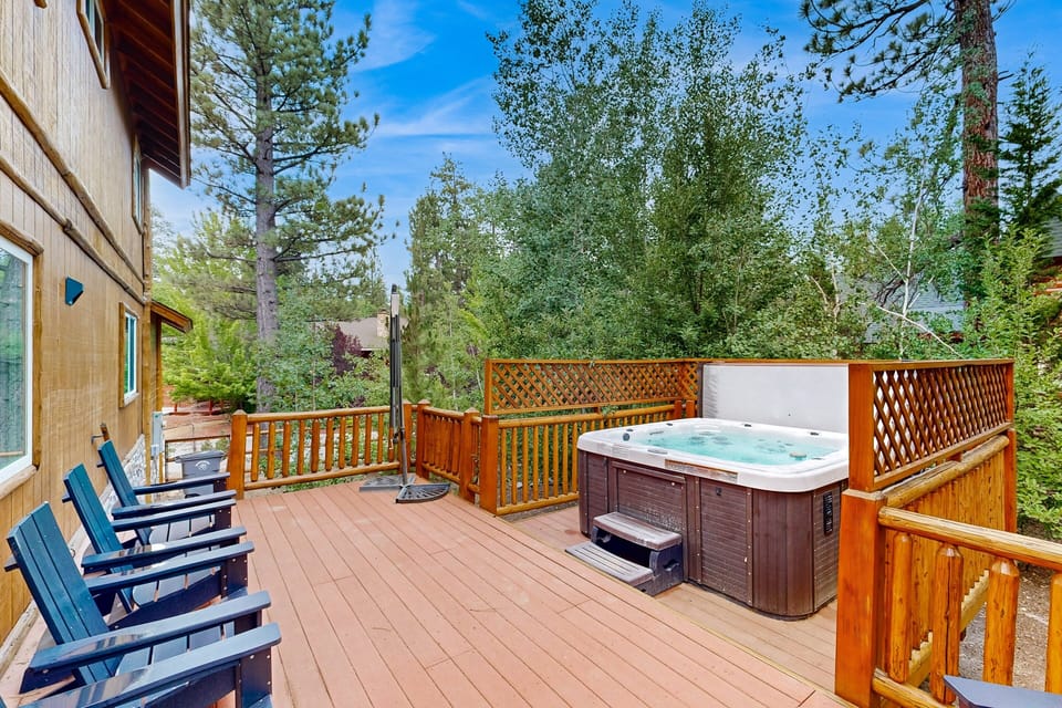 Outdoor area with a hot tub, BBQ grill, and dining table, perfect for relaxing, enjoying meals, and spending time outdoors with family and friends.