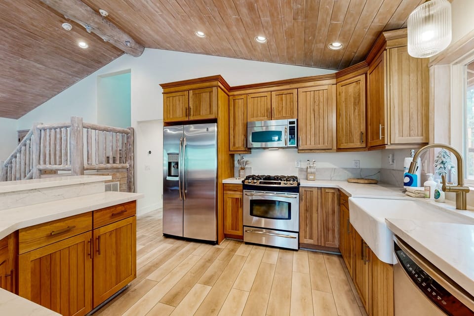Fully equipped cabin kitchen with ample cabinetry, stove, fridge, and coffee maker—perfect for cooking meals, morning coffee, and feeling right at home on your stay.