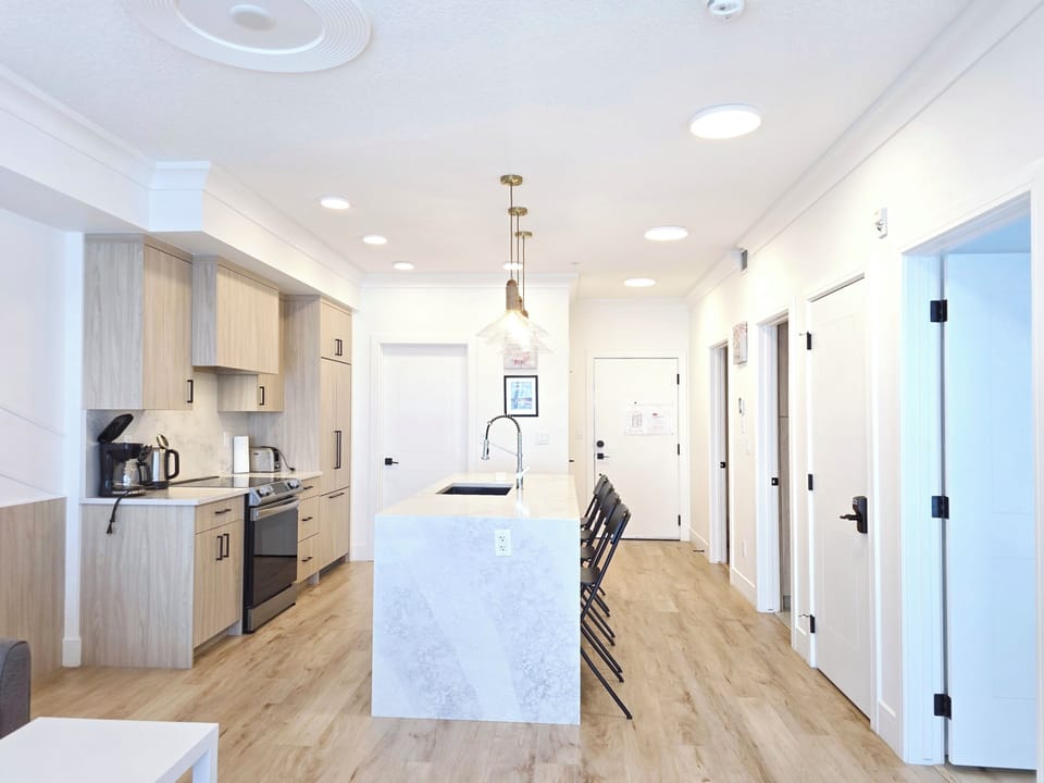 Bright kitchen with island, quartz counters, modern appliances