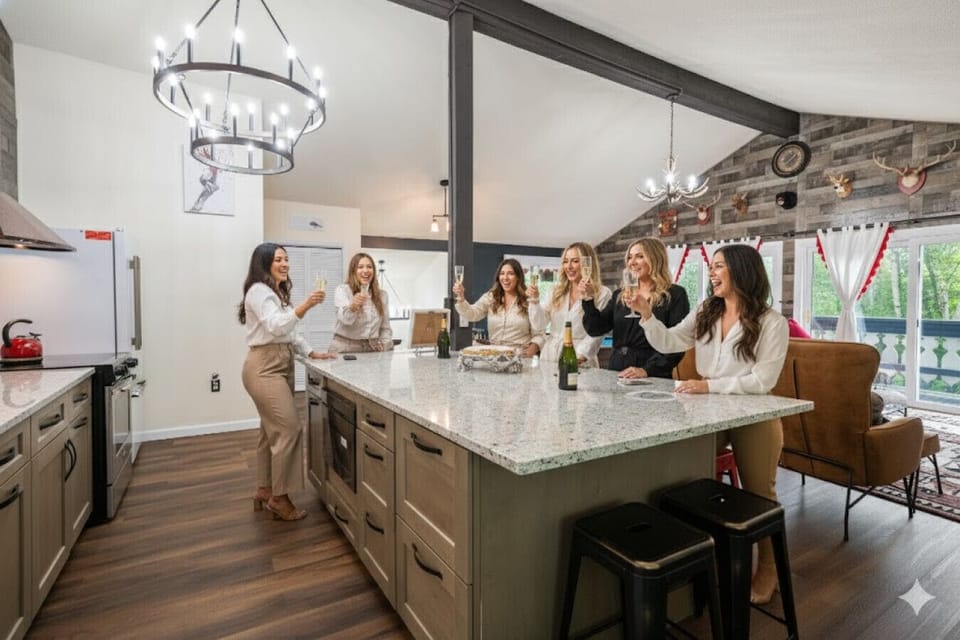 Spacious granite kitchen island seats up to 8 and features two built-in FreePower wireless chargers, a microwave drawer, and included high chair. Perfect gathering space for family meals, celebrations, and group getaways.