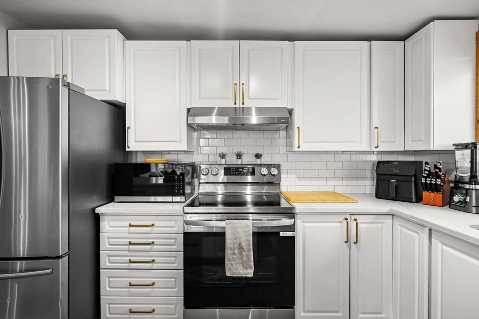 Fully equipped kitchen with stainless appliances and modern finishes