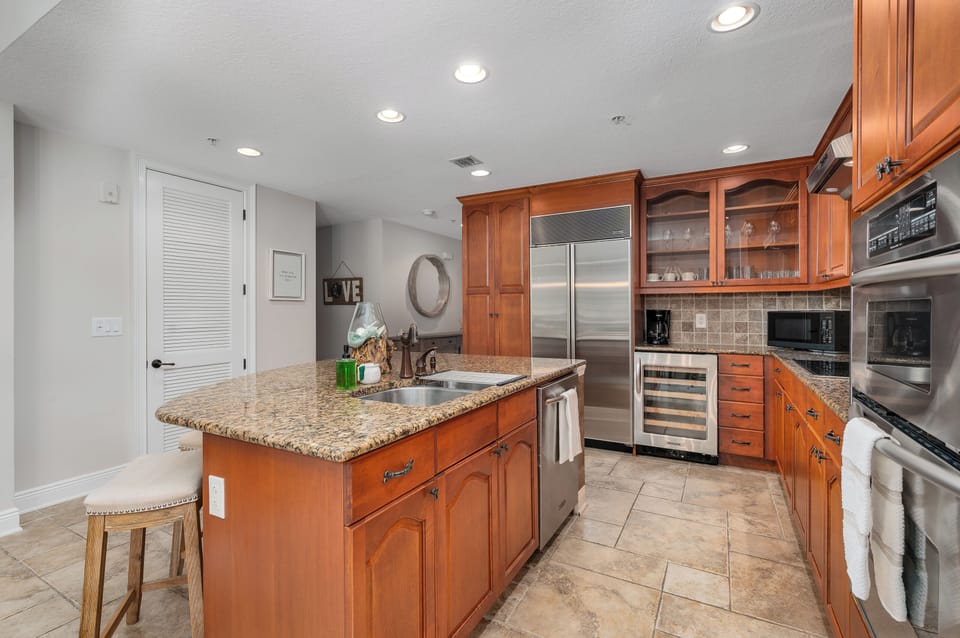 The kitchen features rich wood cabinetry and everything you need to cook like you're home. It’s functional, warm, and family-friendly.