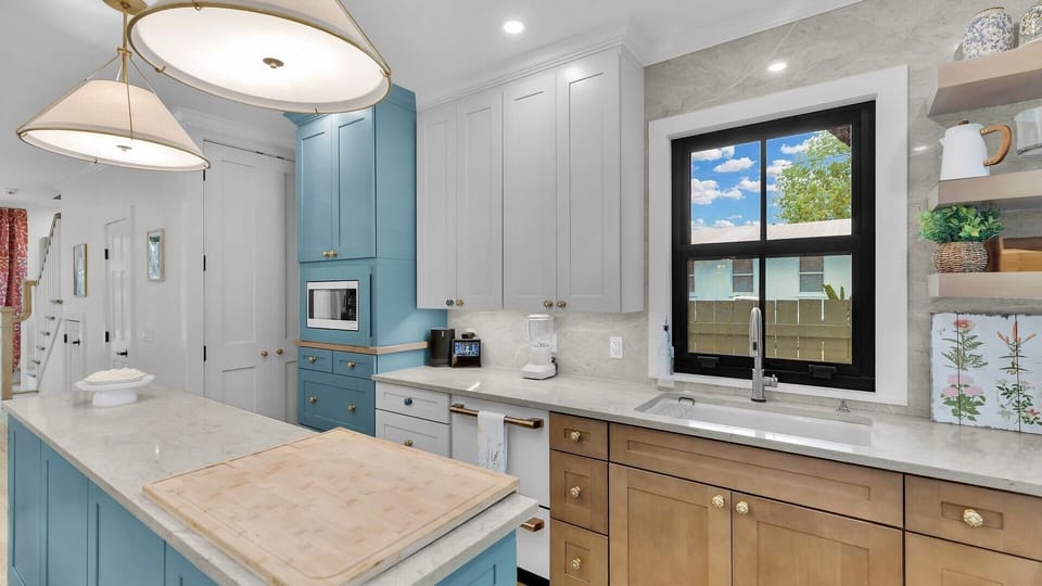 The kitchen's design and appliances are sleek and modern...