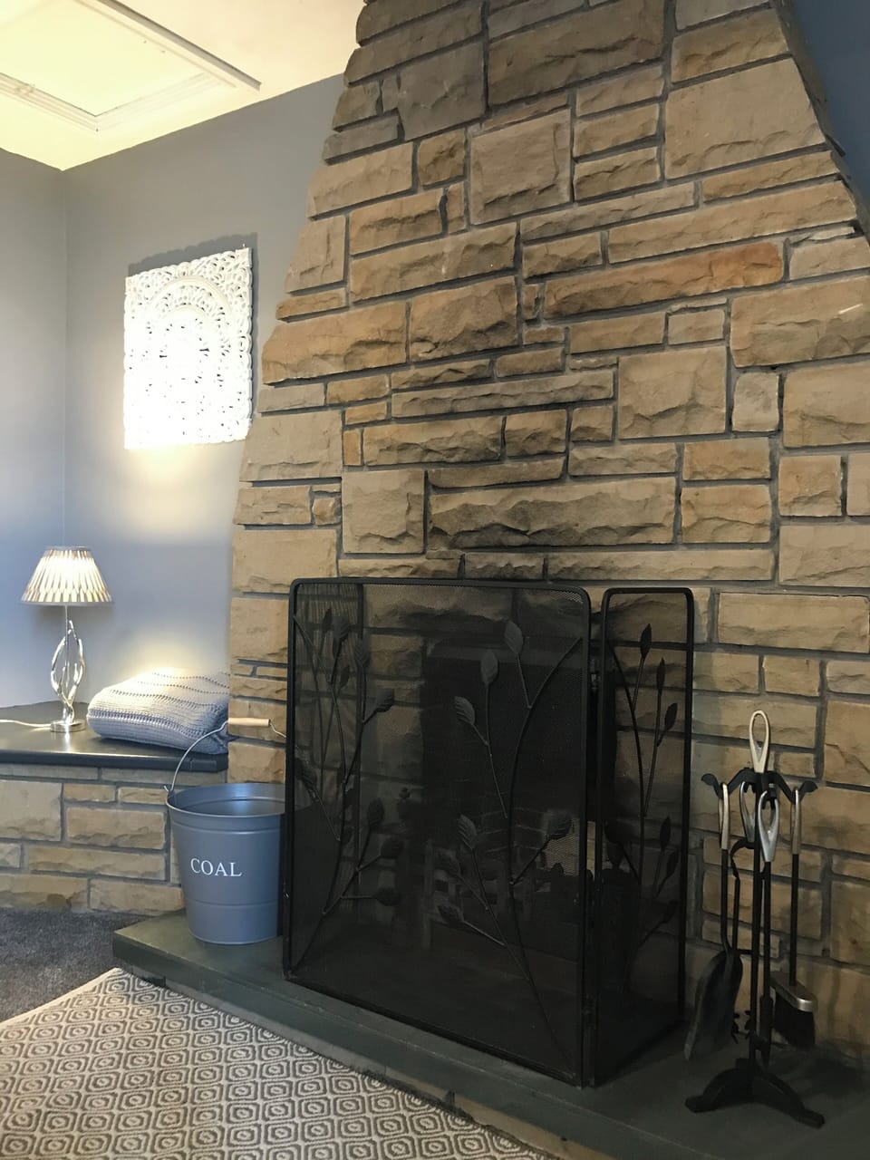 Traditional open fireplace, perfect for creating cozy evening.