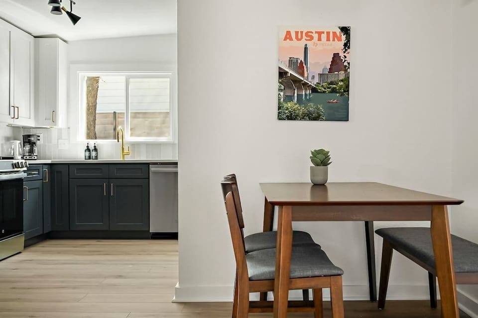 A cozy Austin retreat boasts a charming dining area adorned with tasteful decor an inviting spot to gather & enjoy your meals in style.