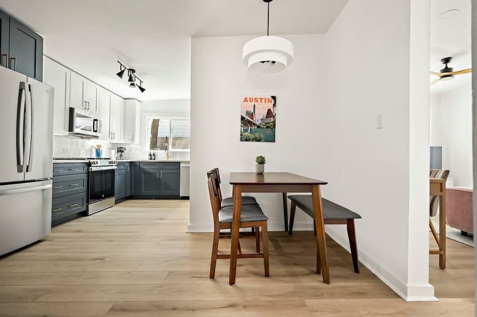 A cozy Austin retreat boasts a charming dining area adorned with tasteful decor an inviting spot to gather & enjoy your meals in style.