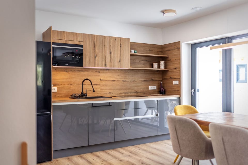 Deluxe Apartment | Private kitchen | Coffee/tea maker, electric kettle, highchair, dining tables