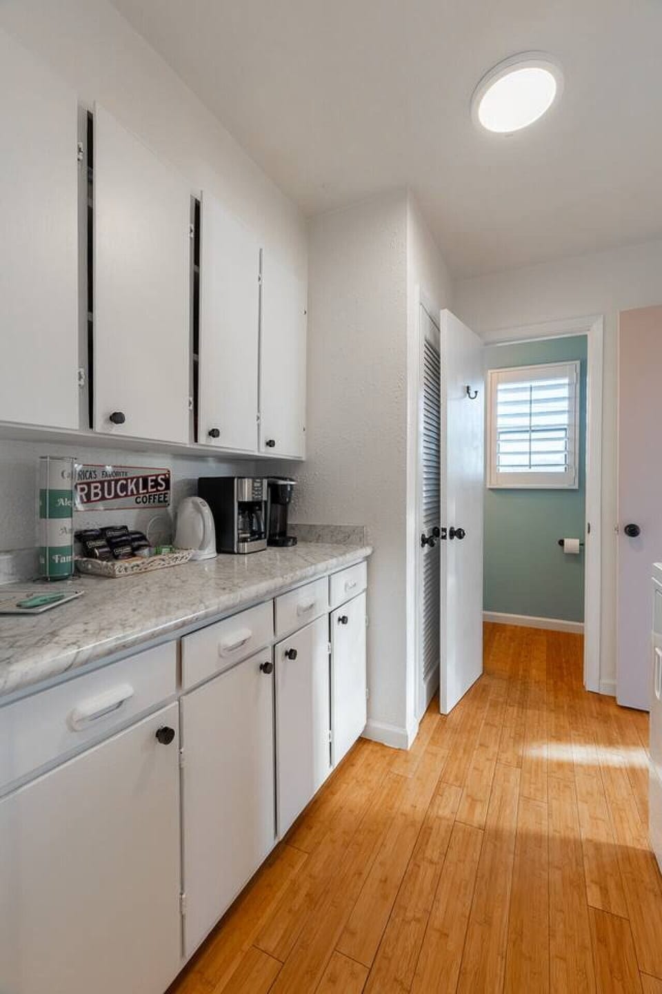 Functional kitchen area with ample counter space and coffee maker—perfect for preparing quick meals or enjoying your morning coffee.