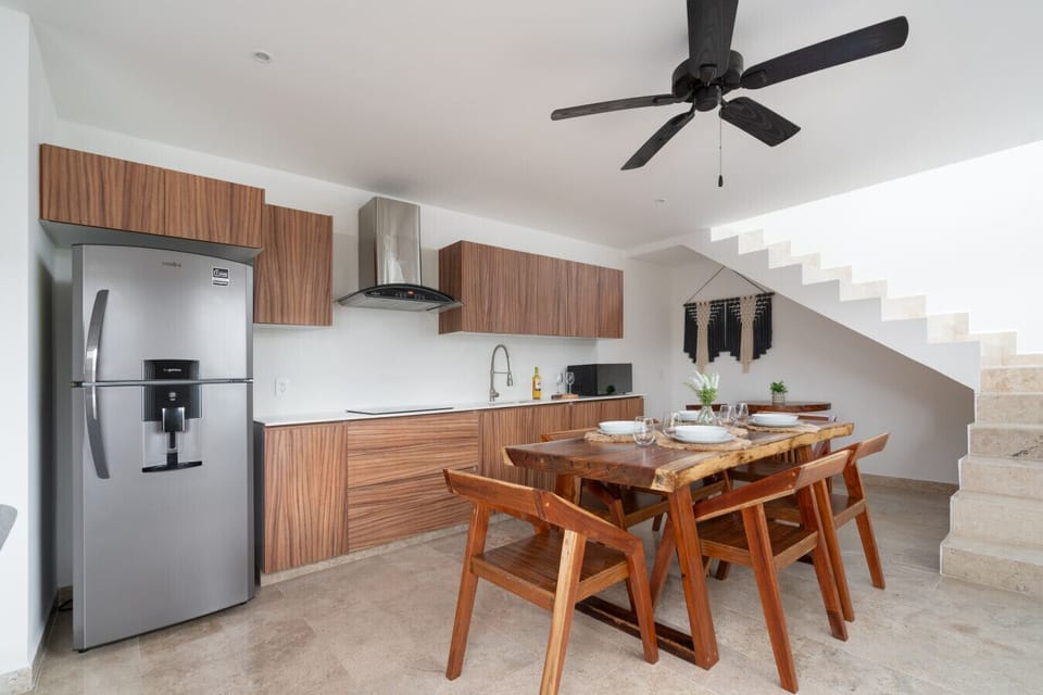 Elegant kitchen with wood accents and stainless steel fridge.