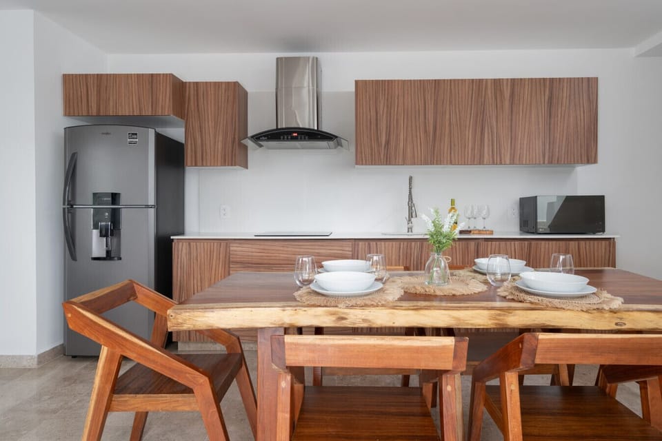 Modern kitchen with wood accents and stylish dining space.