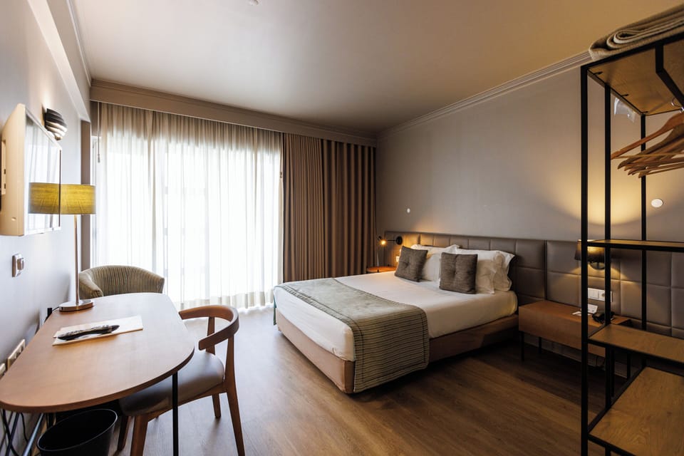 Double Room | Minibar, in-room safe, desk, blackout drapes