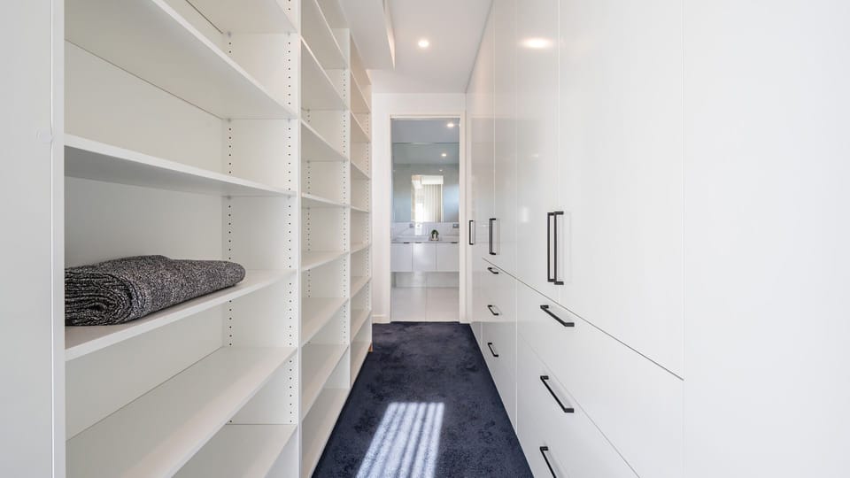 Plenty of storage in master bedroom walk in robe