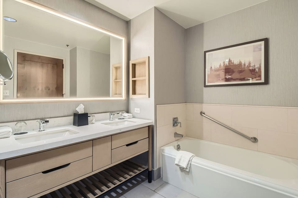 The bathroom includes a double vanity and soaking tub.