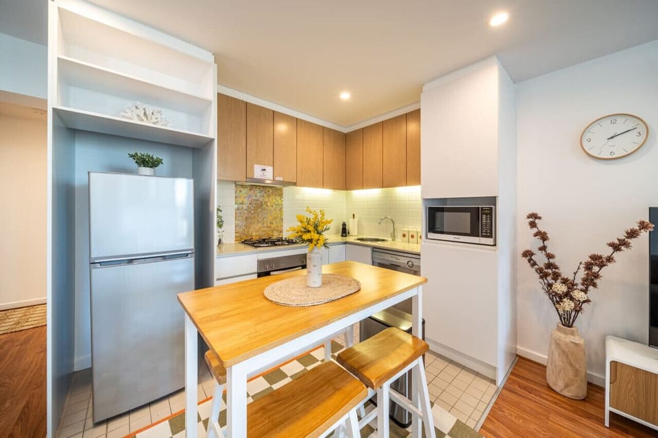 Cook effortlessly in the sleek kitchen, then unwind over a simple meal at home.