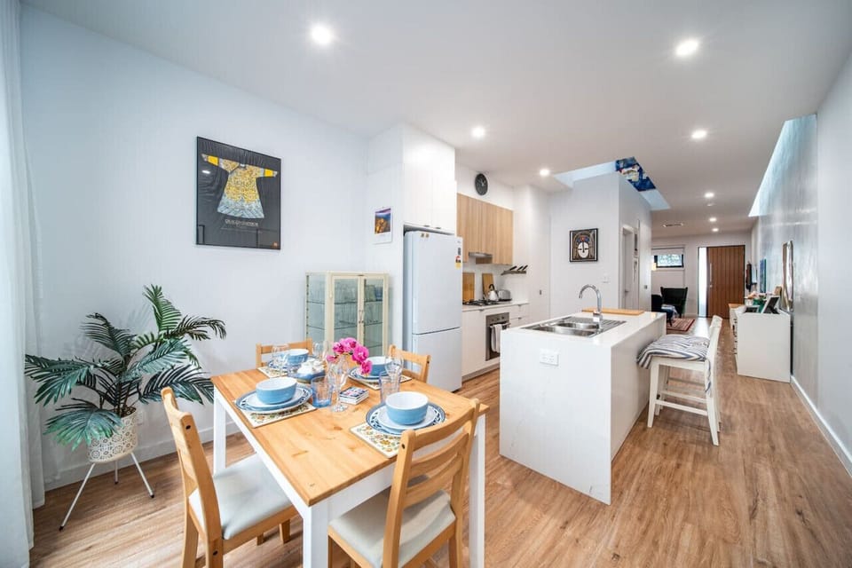 Cook and connect in the open-plan kitchen and dining area, where bar seating and a welcoming table make shared meals easy.