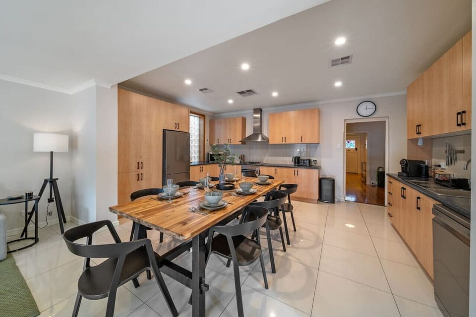 A spacious dining area seamlessly connects to the open kitchen, perfect for gathering and sharing meals.