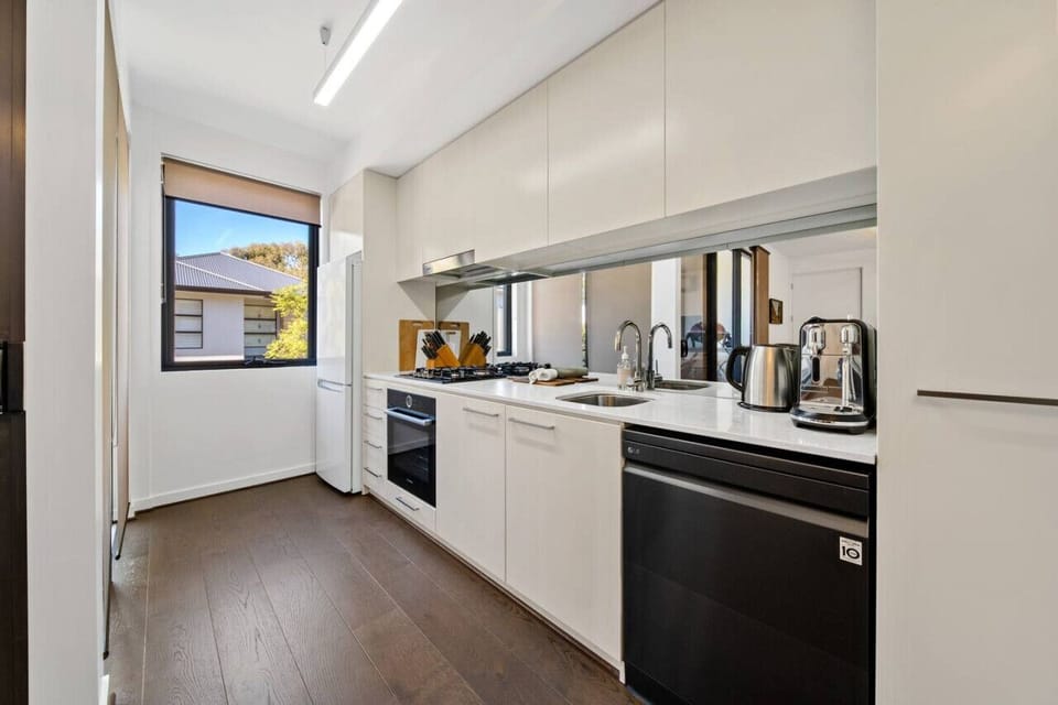 Modern kitchen with gas cooktop, dishwasher, and coffee machine — everything you need to cook with ease.