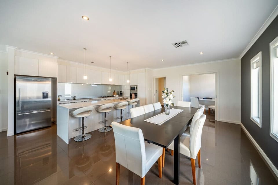 Settle in around the large dining table for shared meals and lingering conversations, with the open-plan layout keeping everyone connected throughout the evening.
