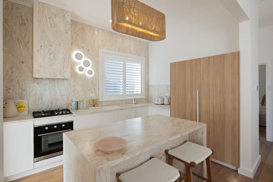 Enjoy preparing meals in the modern kitchen with a central island for casual dining.