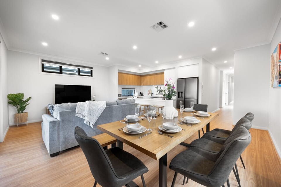 Enjoy long family meals and relaxed conversations around the spacious dining table positioned beside the open-plan kitchen.