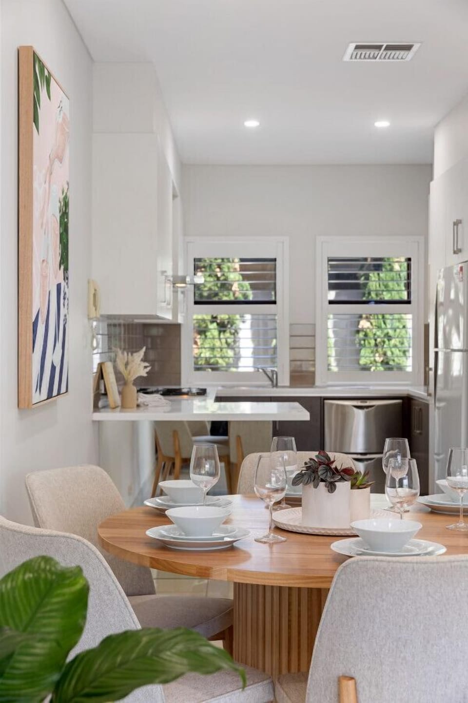 The dining area connects effortlessly to the sleek, well-equipped kitchen, ideal for hosting.
