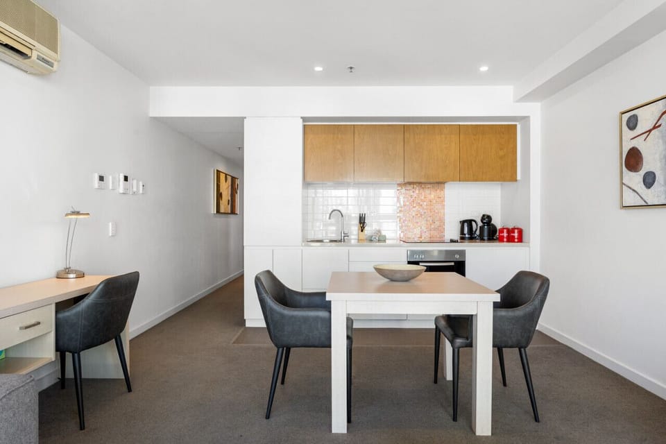 Enjoy slow mornings or easy dinners at the dining table set within the open-plan space.