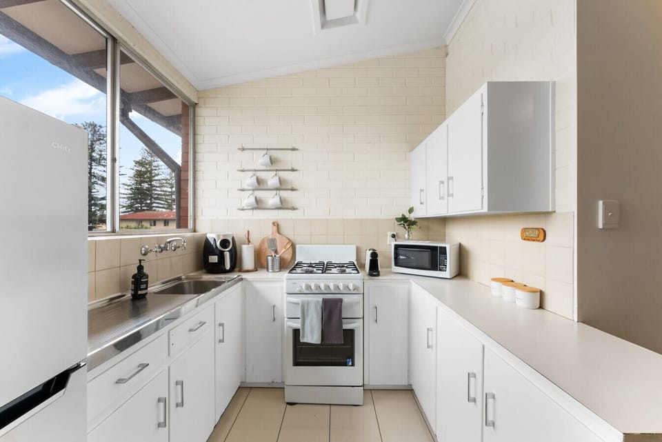 Natural light floods the kitchen, creating an inviting space to cook and enjoy meals.