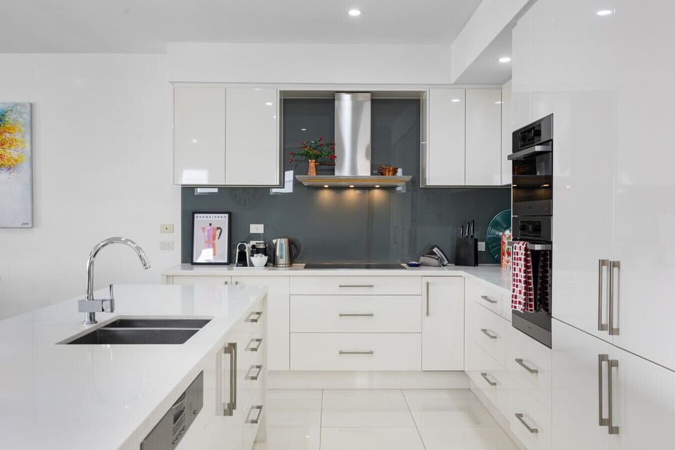 Clean lines, high shine, and all the right appliances — this kitchen’s ready to fuel the day.