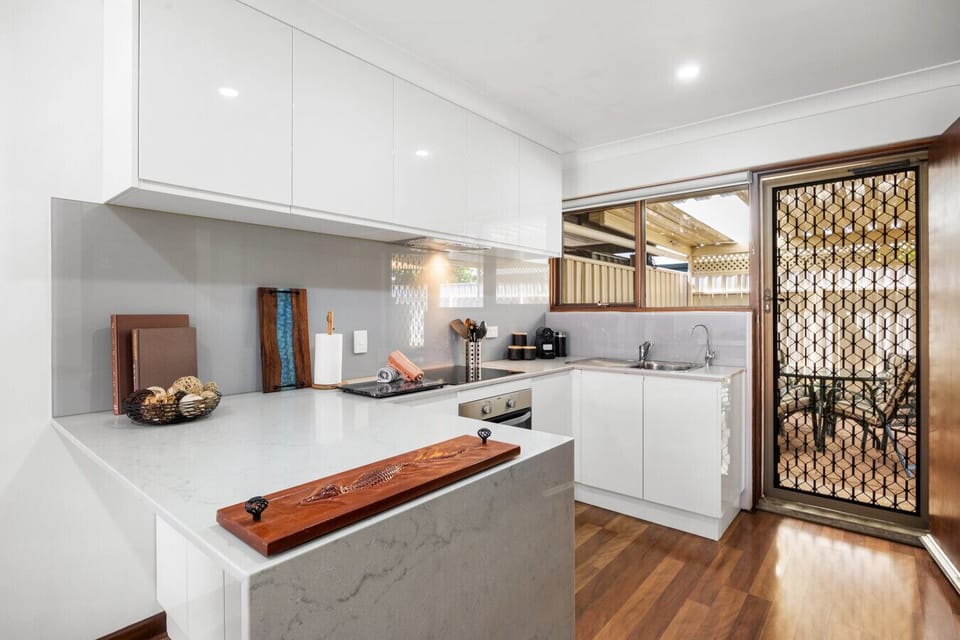Kitchen bench provides a practical space for meal prep and serving.