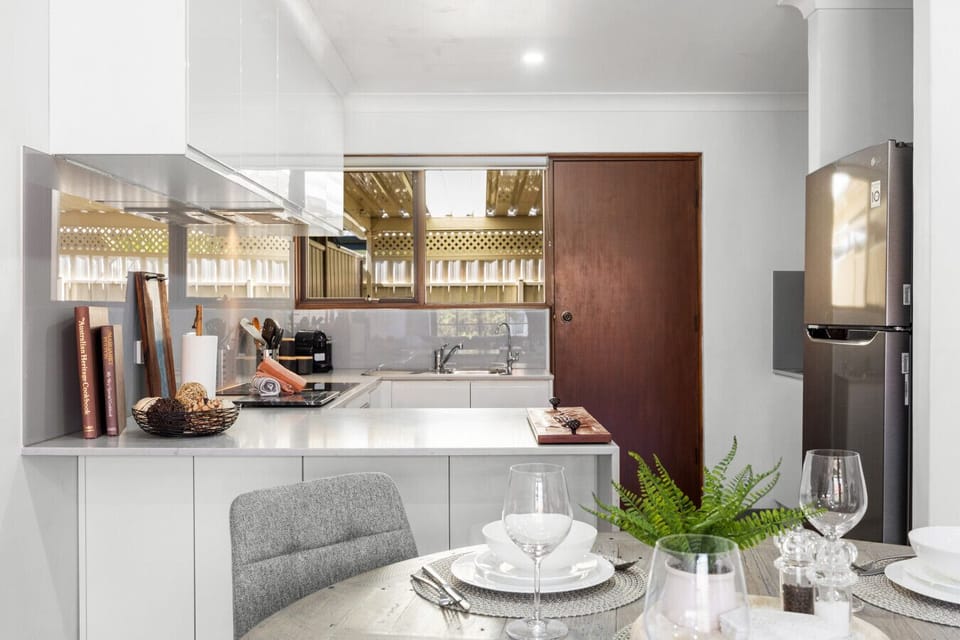 An open layout seamlessly connects the modern kitchen and dining area, perfect for effortless meals and conversations.