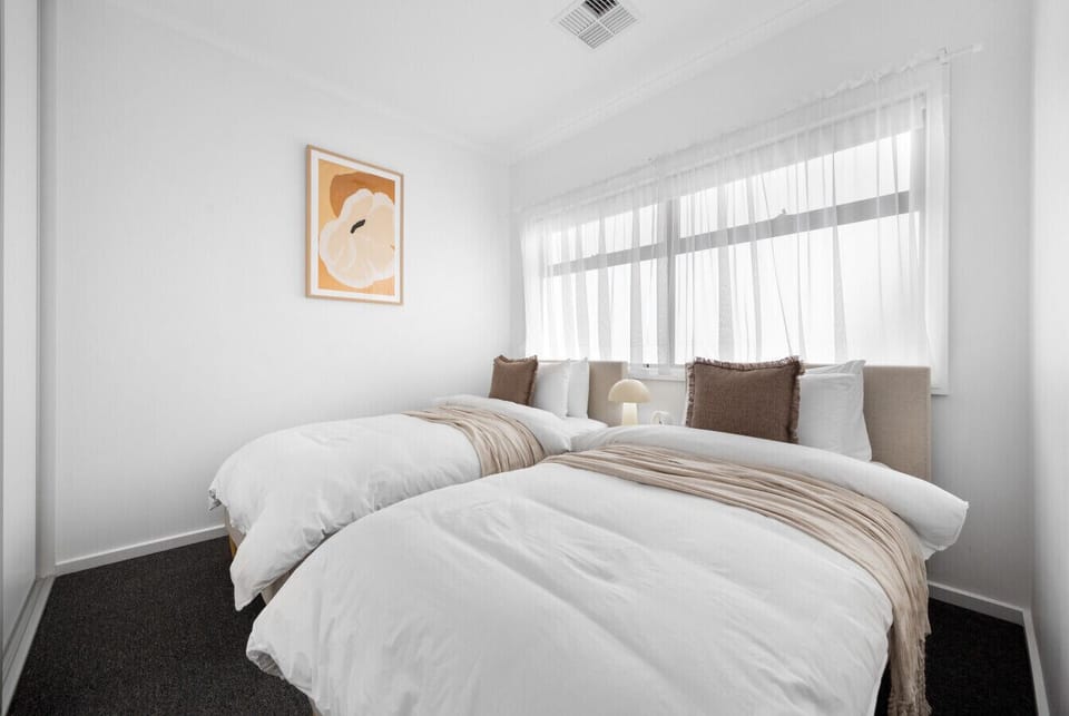Settle into the third bedroom with two single beds, soft bedding, generous storage, and plenty of natural light, ideal for children or friends.