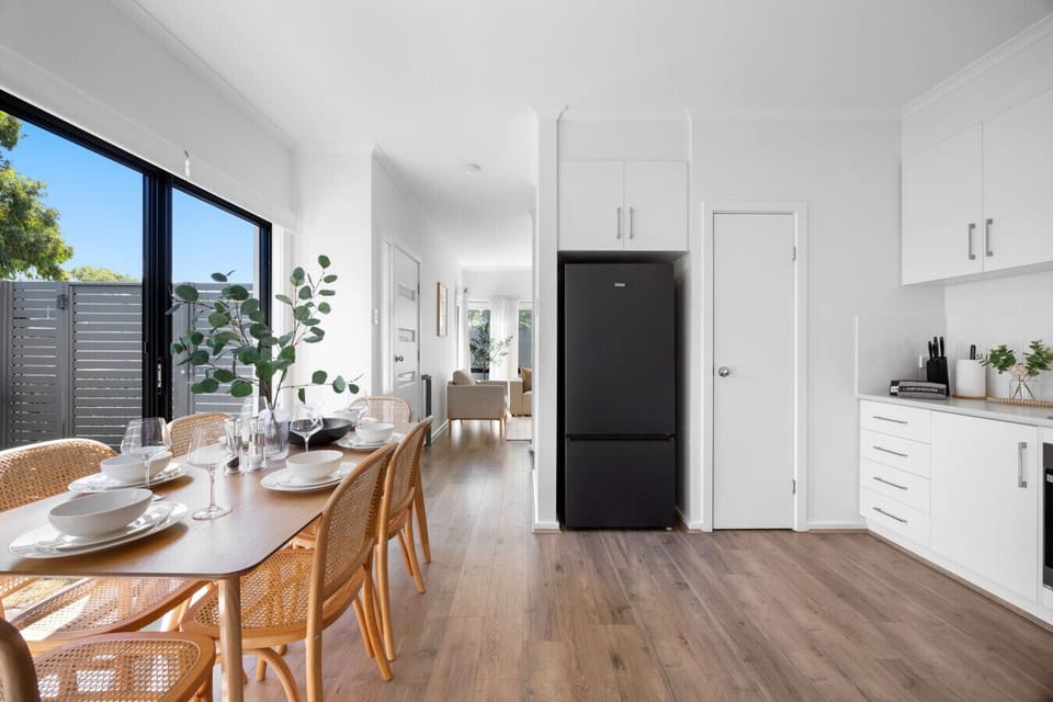 The dining zone ties together the kitchen and living space, making gatherings feel natural and relaxed.