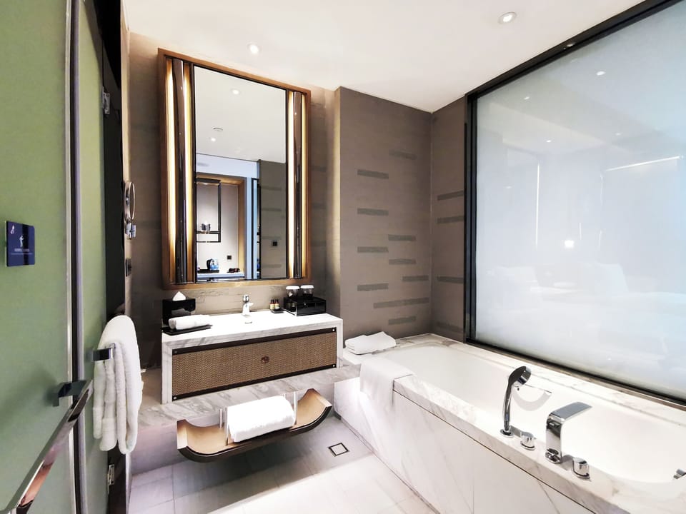 Separate tub and shower, rainfall showerhead, designer toiletries