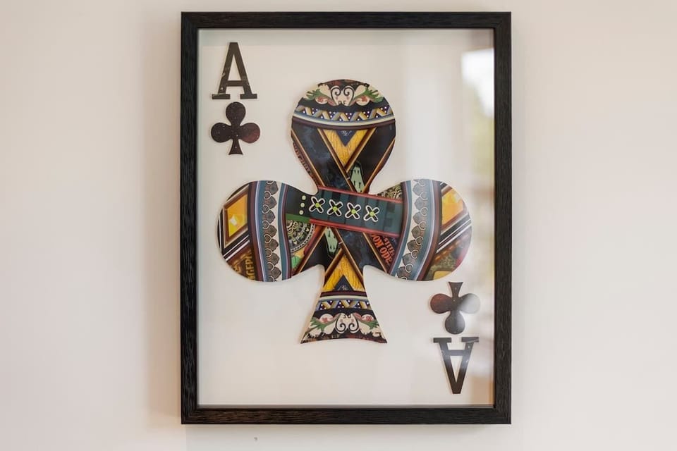 - Unique framed wall art featuring colorful ace of clubs design  
- Adds character and modern style to the vacation rental space  
- Airbnb home decorated with creative touches for a lively stay  
