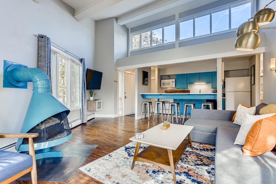 Open living room with vaulted ceiling and eight overhead windows for great light