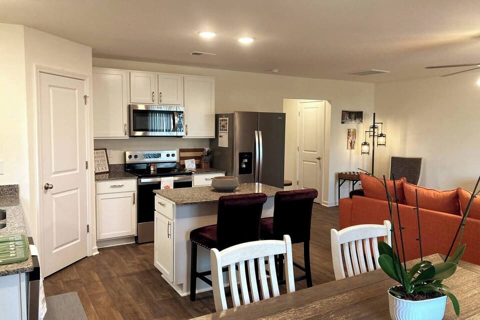 Full kitchen with island seating, dishwasher, pots/pans, basic supplies, stove