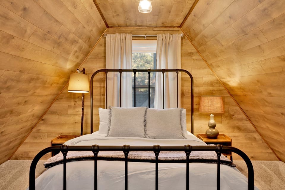 Bedroom with cozy bed, soft lighting, and modern inviting décor.