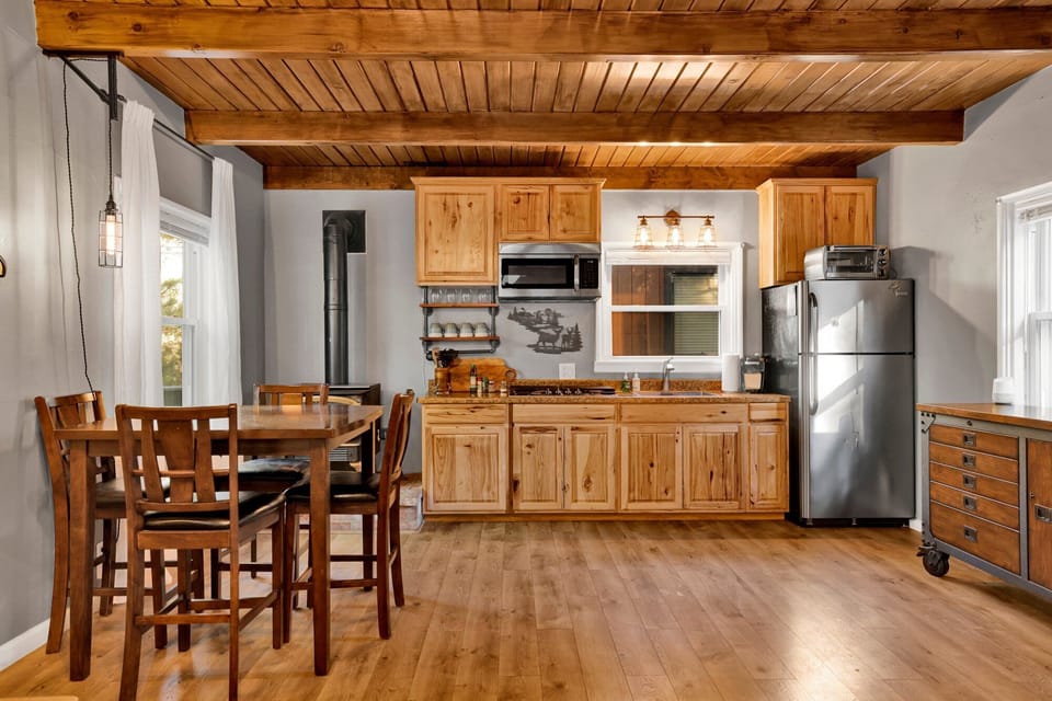 Modern kitchen with sleek counters, bright lighting, and stainless steel.