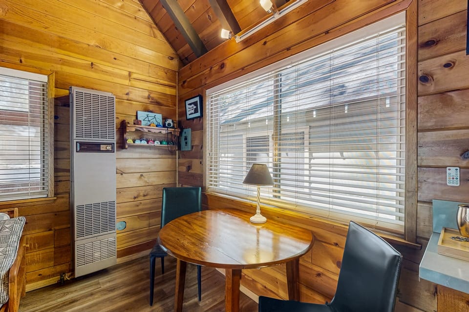 Gather around the dining table, which offers seating for four perfect for meals and game nights.