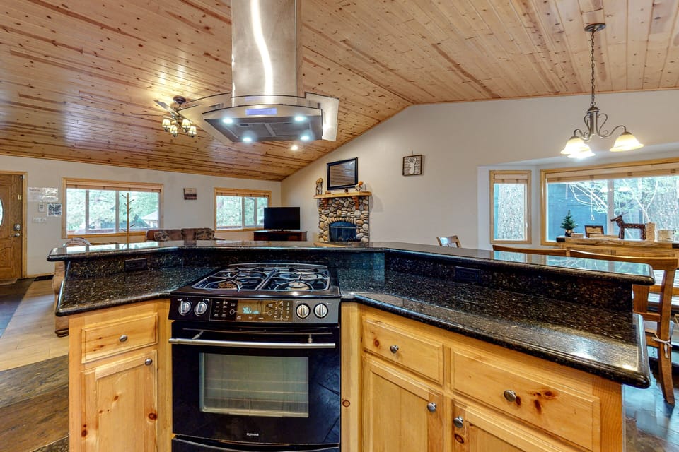 Fully equipped cabin kitchen with ample cabinetry, stove, fridge, microwave, and coffee maker—perfect for cooking meals, morning coffee, and feeling right at home on your stay.