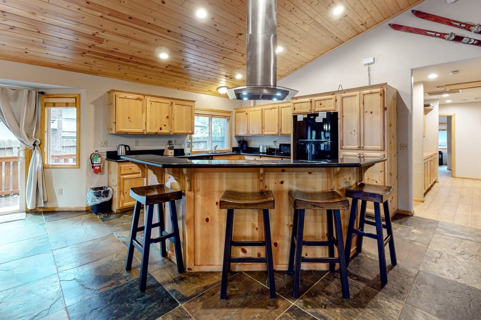 Fully equipped cabin kitchen with ample cabinetry, stove, fridge, microwave, and coffee maker—perfect for cooking meals, morning coffee, and feeling right at home on your stay.