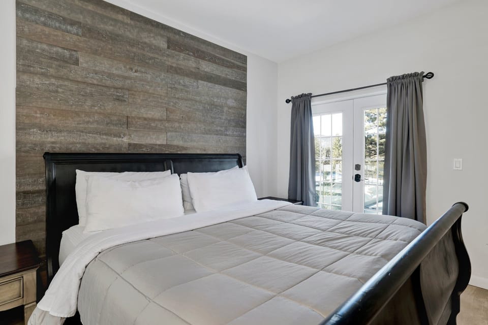 Peaceful cabin bedroom with plush bedding, and beautiful views—ideal for restful nights, cozy mornings, and a relaxing mountain escape.