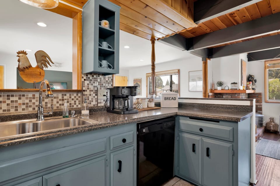 Fully equipped cabin kitchen with ample cabinetry, stove, fridge, and coffee maker—perfect for cooking meals, morning coffee, and feeling right at home on your stay.