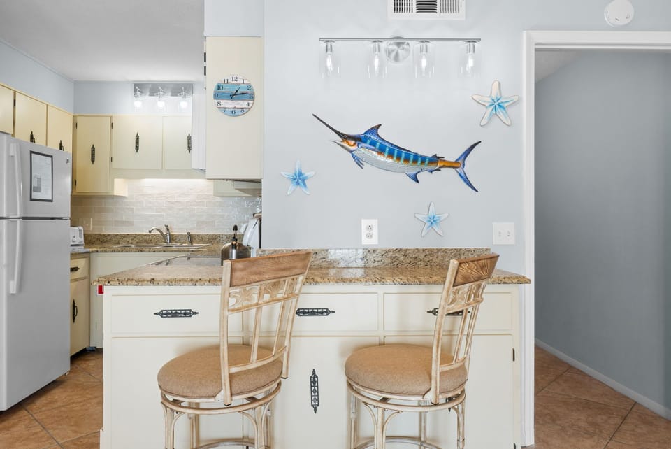 Breakfast bar with 2 barstools and updated coastal decor