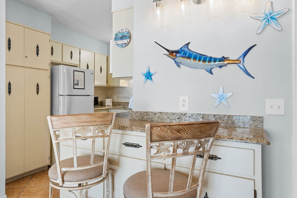Breakfast bar with 2 barstools and updated coastal decor