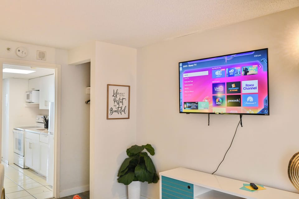 Relax in a stylish  bedroom with queen-size bed, TV, and sofa seating.