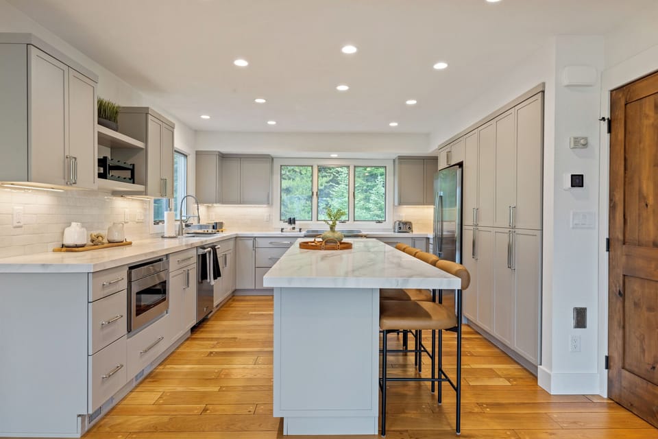 Step into your beautifully designed kitchen with sleek marble countertops, warm wood floors, and everything you need to whip up a delicious meal. Natural light pours in, making this space as inviting as it is functional.