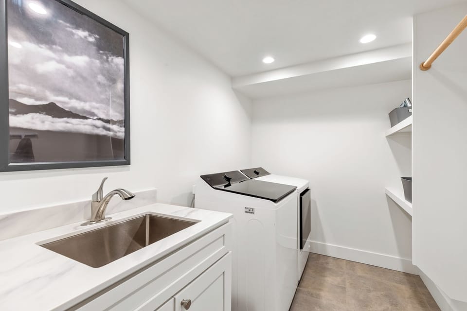 A pristine laundry space awaits with modern appliances and a utility sink, making it effortless to keep your vacation wardrobe fresh throughout your stay.